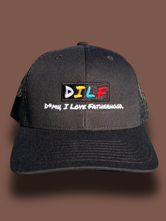 Classic DILF trucker hat with black front panel and embroidered D*mn I Love Fatherhood logo on a brown background